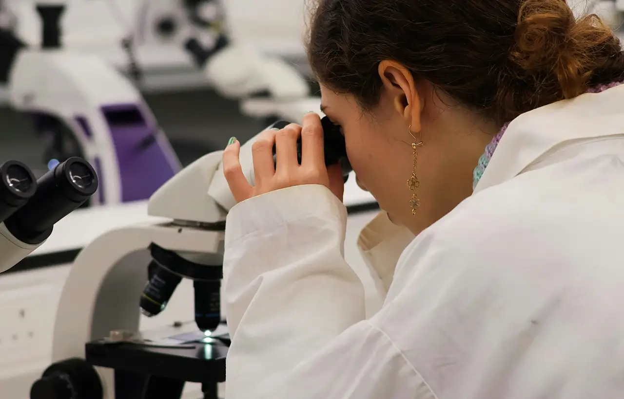 A doctor looking through a microscope